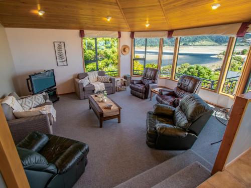 a large living room with couches and a tv at Aorere House - Collingwood Holiday Home in Collingwood