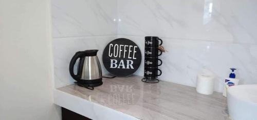 a kitchen counter with a coffee bar sign on it at Point Gate Inn in Bacolod