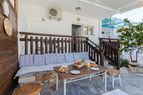 a table with a bowl of fruit on a patio at Christos studios and family apartments in Rhodes Town