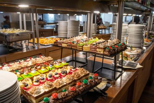 a buffet line with many different types of food at CE Plaza Hotel in Siófok