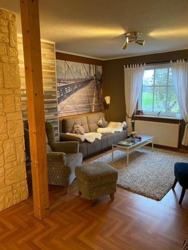 a living room with a couch and a table at Landhaus Galke in Hude