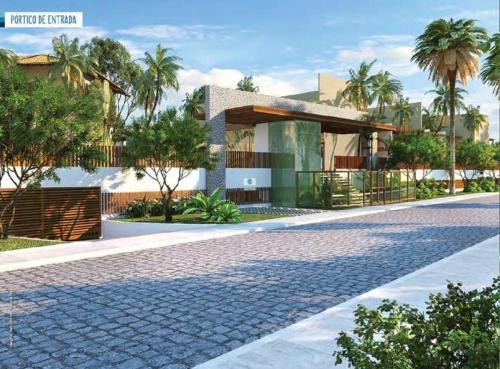 a house with palm trees and a cobblestone street at TAVARUA ITACIMIRIM d in Itacimirim