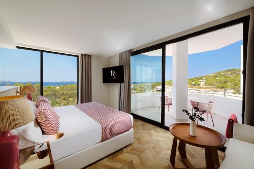 a hotel room with a bed and a balcony at TRS Ibiza Hotel -Adults Only in San Antonio