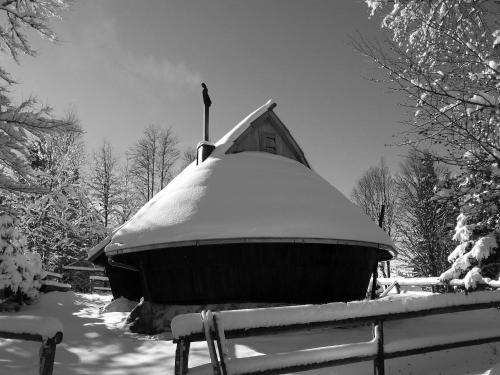 a boat covered in snow on top of a fence at Chalet Kanja Velika Planina in Stahovica
