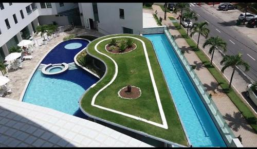 an aerial view of a swimming pool with a resort at Tambaú Beach Paradise in João Pessoa