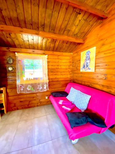 a room with a pink couch in a wooden room at Canary Wild House 2 in Carrizal