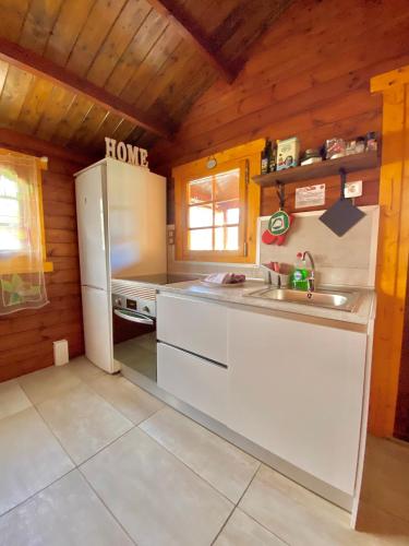 a kitchen with a white refrigerator and a sink at Canary Wild House 2 in Carrizal