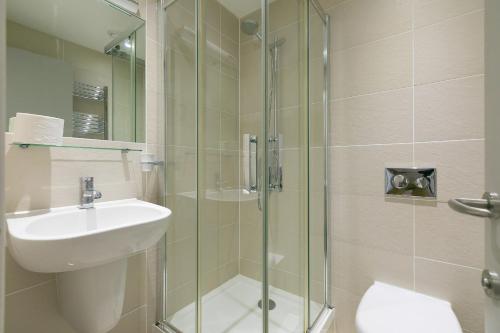 bagno con lavandino e doccia in vetro di Puffins a St Ives