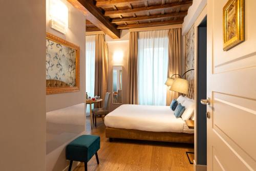 a hotel room with a bed and a table at Le Suite del Barone in Rome