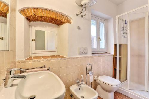 a bathroom with a sink and a toilet and a mirror at Casale Pozzo al Moro in Marina di Campo