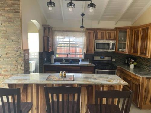 a kitchen with a large island in the middle at Slice of Paradise in Ocho Rios