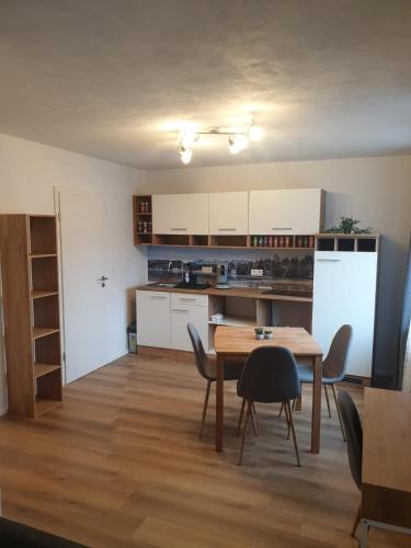 a kitchen and dining room with a table and chairs at Ferienwohnung Luitpold 2 in Memmingen