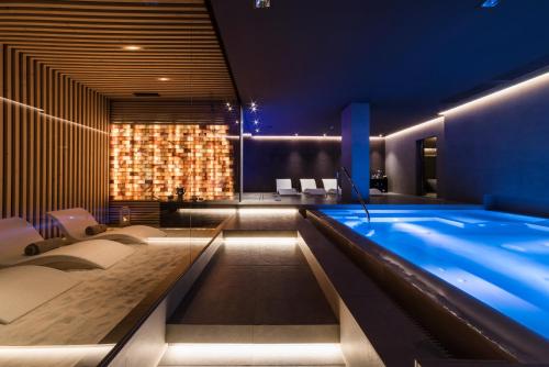 a swimming pool in a hotel room with lights at D'Aragona Lifestyle Hotel in Conversano