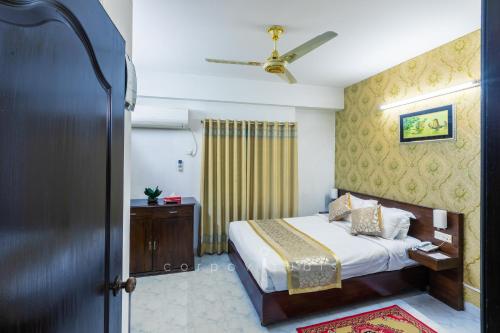 a bedroom with a bed and a ceiling at Sel Nibash Hotel & Serviced Apartments in Dhaka