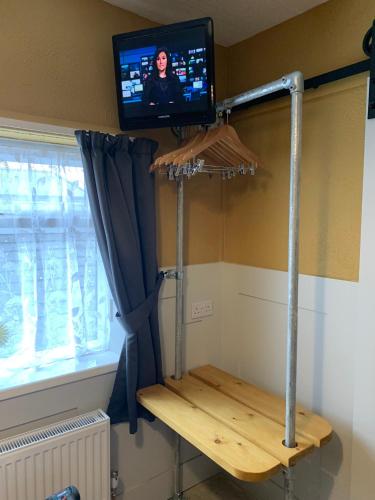 a room with a tv and a shelf with a tv at The Woodleigh family hotel in Blackpool