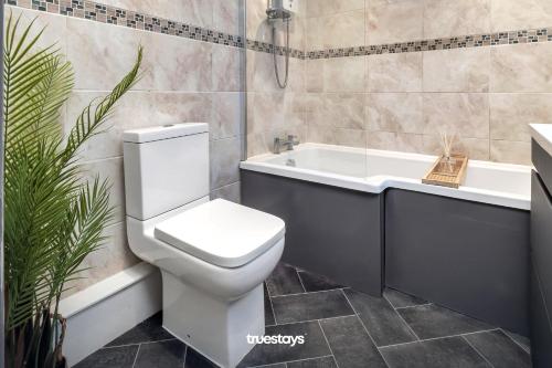 W łazience znajduje się biała toaleta i wanna. w obiekcie Chorlton House by Truestays - NEW 2 Bedroom House in Stoke-on-Trent w mieście Hanley