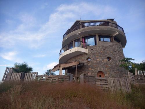 a round house on top of a stone tower at Casa Fabrice in Ribeira da Prata