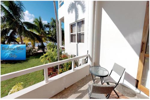 a balcony with a chair and a sign that reads borman blue at Brahma Blue Resort in San Pedro