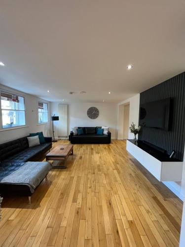 a living room with a couch and a flat screen tv at NE1 Luxury City Centre Apartment in Newcastle upon Tyne