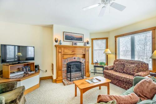 a living room with a fireplace and a tv at Inviting Ski-inandSki-out Condo at Jay Peak Resort! in Jay