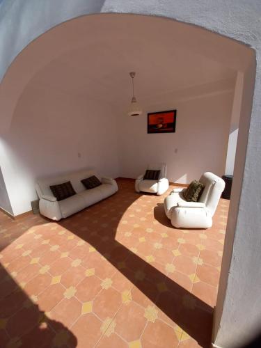 a living room with two chairs and a couch at Corral de Piedras in Humahuaca