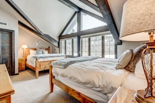 a bedroom with two beds and a window at Tavern Inn #15 in Olympic Valley
