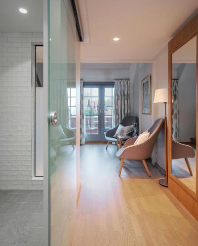 a living room with a glass door leading to a living room at Engø Gård Hotel & Restaurant in Tjøme