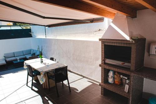 a outdoor patio with a table and a fireplace at Casa Mourinha - Portimao, Algarve in Portimão