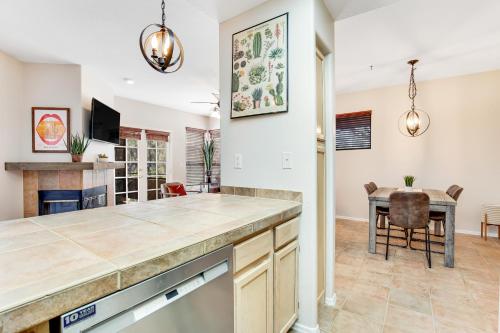 a kitchen with a table and a dining room at Canyon Crest Condo in Tucson
