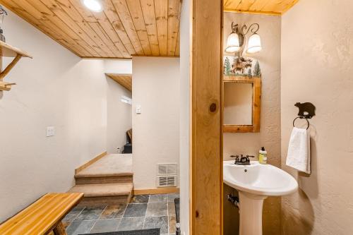 a bathroom with a sink and a bed in the background at Coal Creek Cabin in Snoqualmie Pass