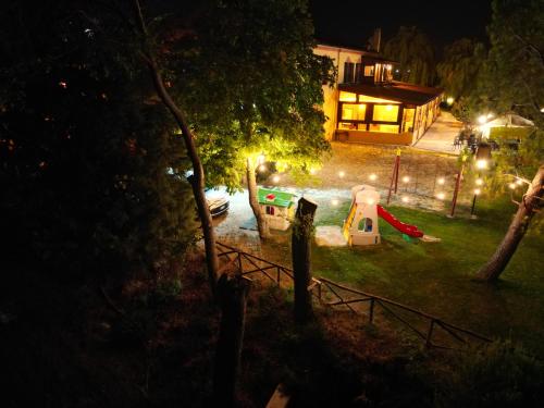 a backyard at night with a playground and a house at Masseria La Guardata in Guglionesi