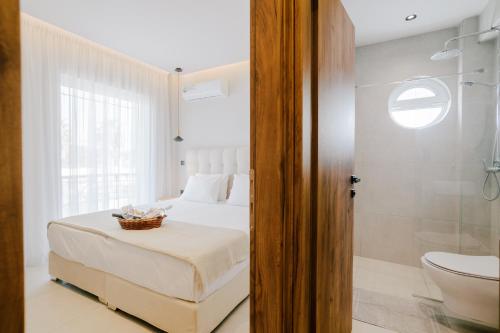 a bedroom with a bed and a bathroom with a toilet at Aelia Prime Experience 1 in Kos