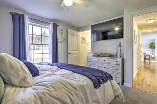 a bedroom with a bed and a dresser and a window at NEW! Updated Mystic Home w/ Sauna, Hot Tub & Deck in Mystic
