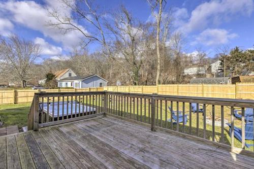 a wooden deck with a fence and a yard at NEW! Updated Mystic Home w/ Sauna, Hot Tub & Deck in Mystic