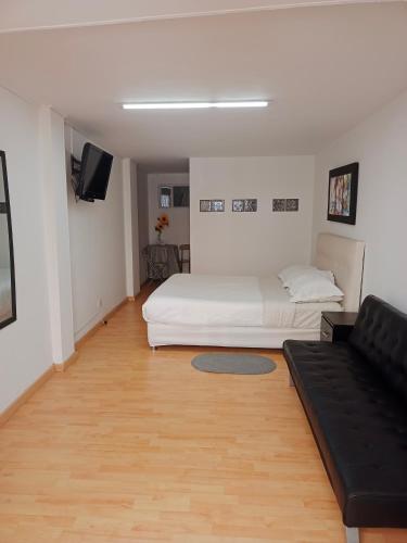 sala de estar con cama y sofá en V&B Apartamento, en Bogotá