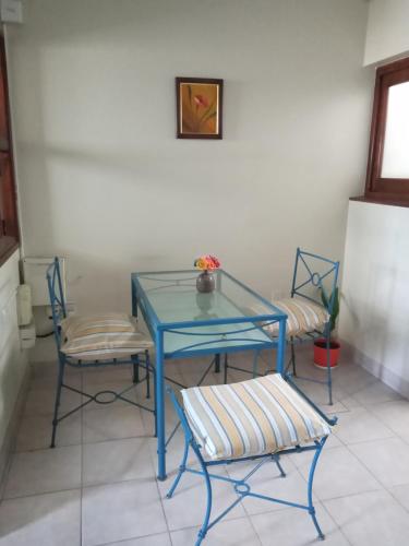 a blue table and two chairs in a room at Chalet del Rosedal in San Salvador de Jujuy