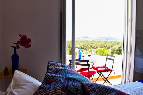 a bedroom with a bed and a view of a balcony at Heaven's Edge in São Brás de Alportel