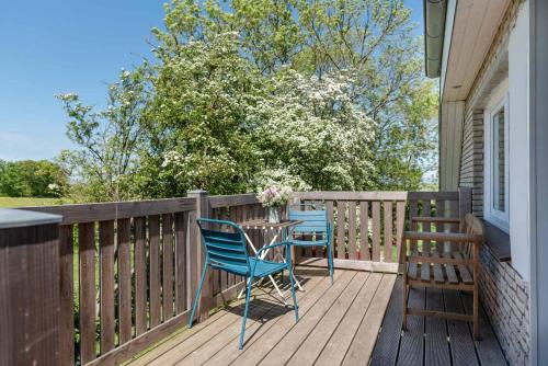 a patio with two chairs and a table on a deck at Loft auf Fehmarn 800m zum Strand in Fehmarn