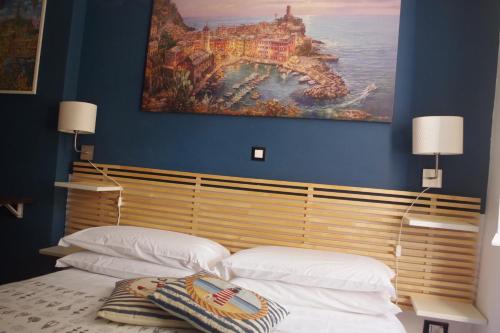 - une chambre avec 2 lits et un tableau mural dans l'établissement Ca Du Grifun, à Vernazza