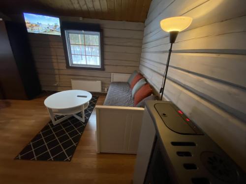 a small room with a couch and a table at Camping Fredrika-Braber in Fredrika