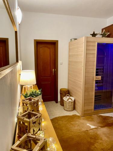 a room with a table and a wooden cabinet at Vila EVIO Třeboň in Třeboň