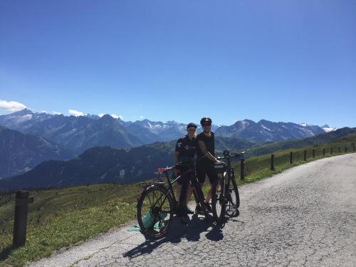two people standing next to their bikes on a road at Ferienwohnung Gruber-Hansen in Kaltenbach