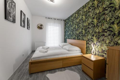 una camera con letto e parete verde di Apartament Rodzinny - Lamelowy Domek a Kudowa-Zdrój