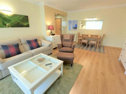 a living room with a couch and a table at Carnaxide modern T1 apartment w balcony in Carnaxide Oeiras Lisbon in Carnaxide