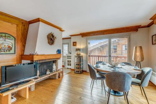 a dining room with a table and a fireplace at Superb and calm flat with balcony in Megève - Welkeys in Megève