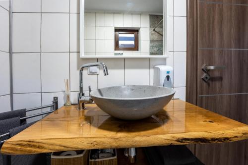 a bowl sink on a wooden counter in a bathroom at Vila Veve in Sighişoara