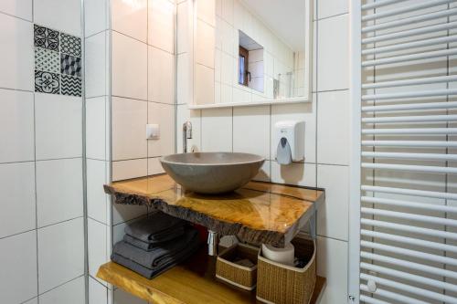 a bathroom with a bowl sink on a counter at Vila Veve in Sighişoara
