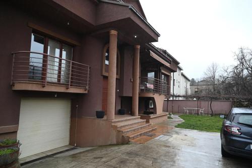 a house with a car parked in front of it at BOGO Apartment in Bitola