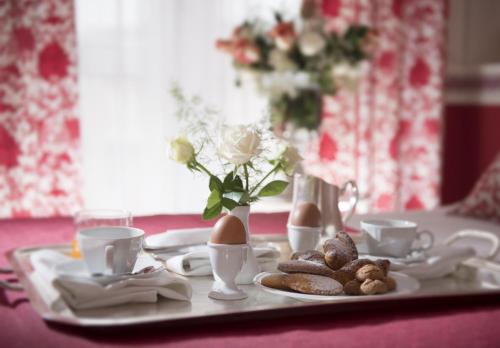 a table with a tray with a plate of food at Hotel Milton Rimini in Rimini