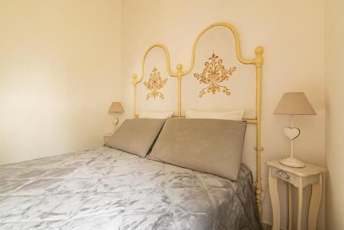 um quarto com uma cama com uma moldura dourada em Casa Lilliosa em San Pasquale
